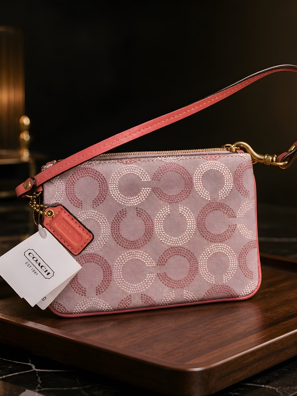 Coach Wrislet Dotted Op Art" print and trimmed with premium leather. 